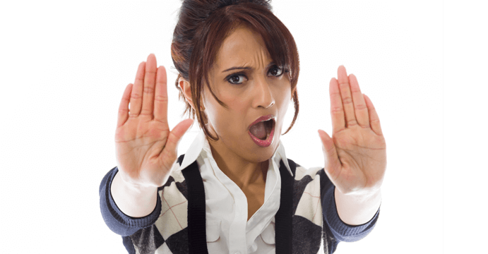 Businesswoman holding hands out to stop someone