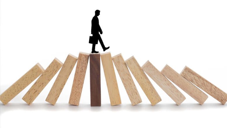 Man walking on a structure of dominos