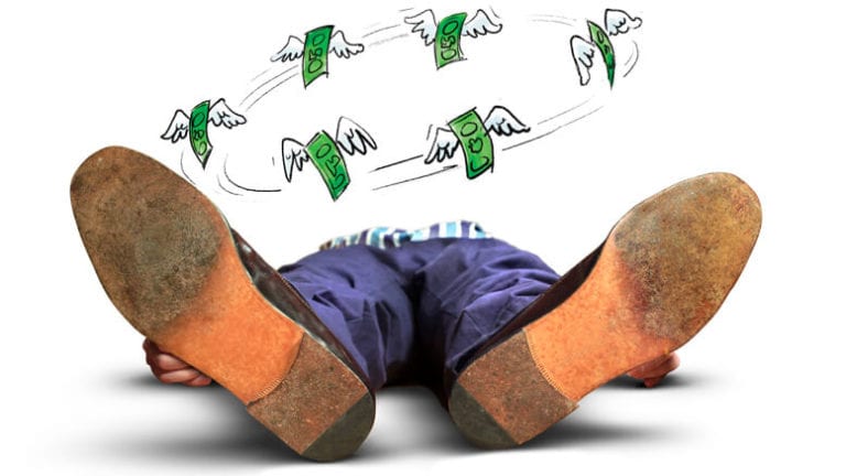 Person lying down with money circling his mind