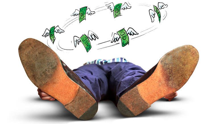 Person lying down with money circling his mind