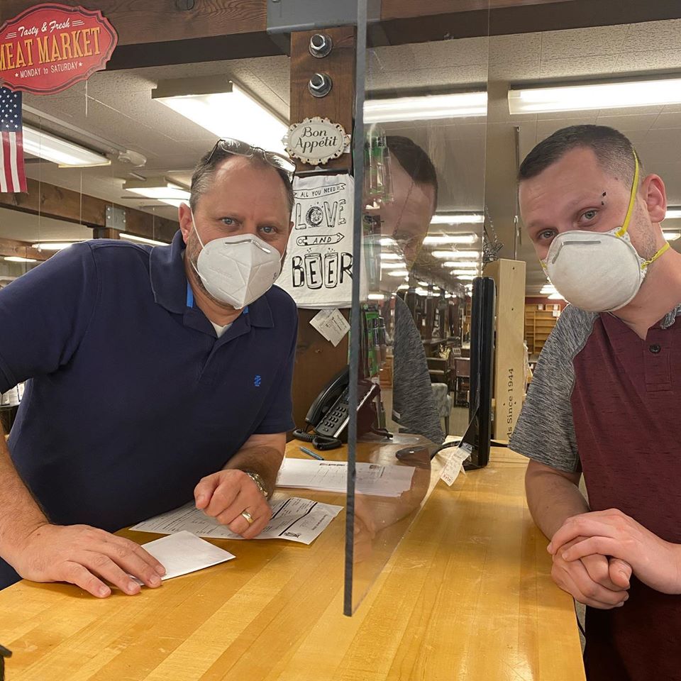 Image shows two men wearing face masks.