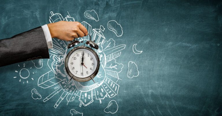 Business Man holding a clock depicting time managment
